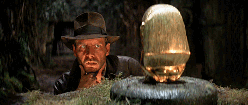 Indiana Jones examines golden idol gif