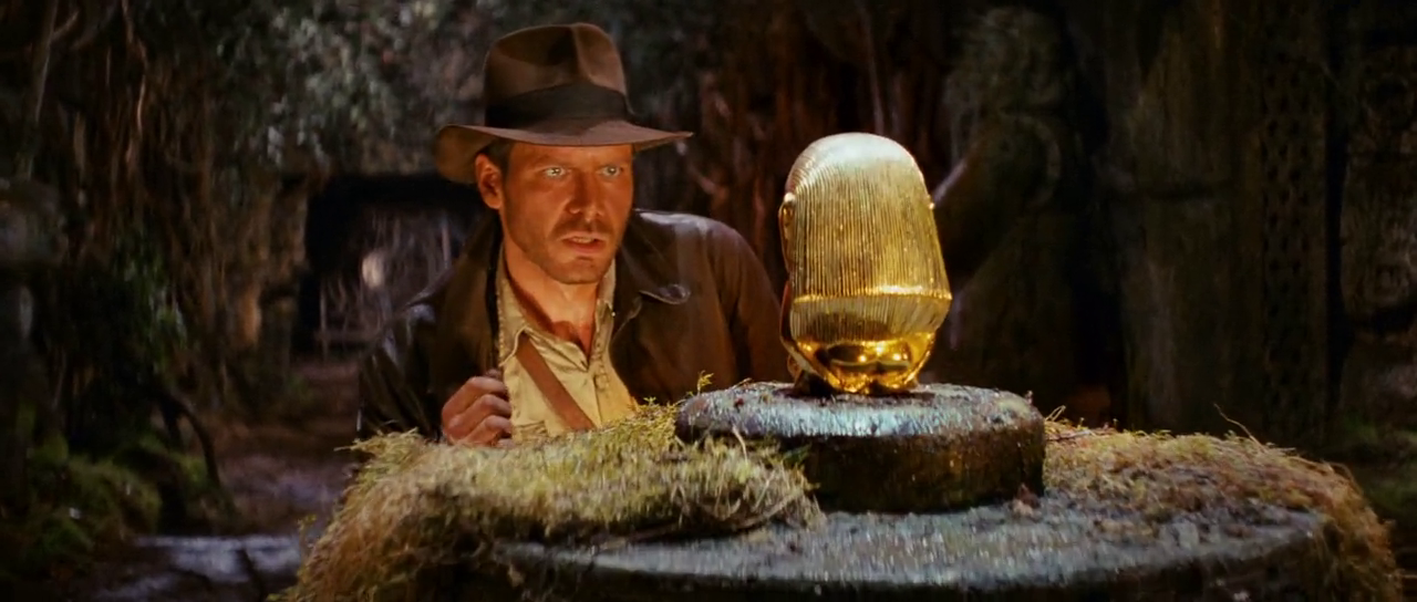 Indiana Jones crouches at golden idol