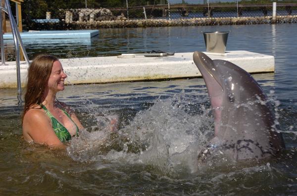 Bethany and dolphin splashing