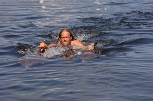 Me being pulled through water by two dolphins