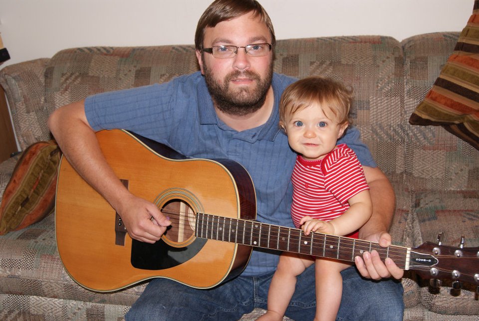 Michael with acoustic guitar and Reagan