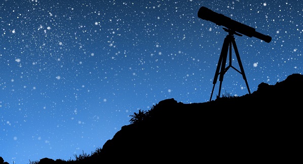 Small telescope on hill pointed at stars